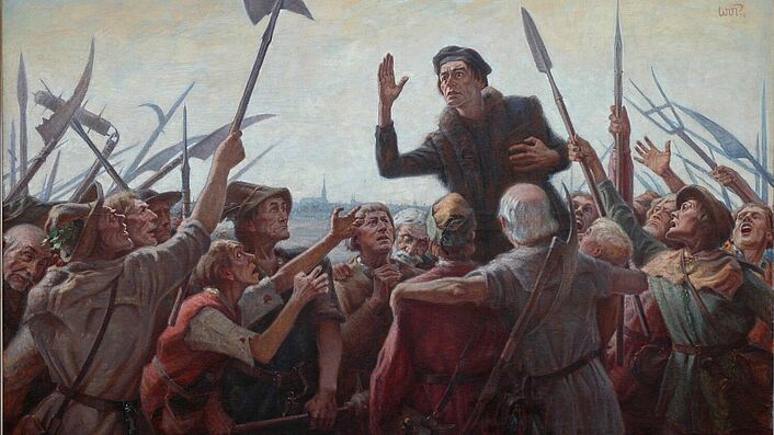 Das Bild zeigt den Reformator und Bauernführer Thomas Müntzer, der zu den aufständischen Bauern predigt. Müntzer überragt seine Zuhörer, deren teils begeisterte, teils flehenden Blicke auf ihn gerichtet sind. Die Aufständischen sind einfach gekleidet. Sie sind mit umgeschmiedeten Sensen, Spießen, Helebarden, Keulen und Beilen bewaffnet. Im Hintergrund des Bildes ist ganz schwach eine Stadt mit einer großen Kirche zu erkennen.