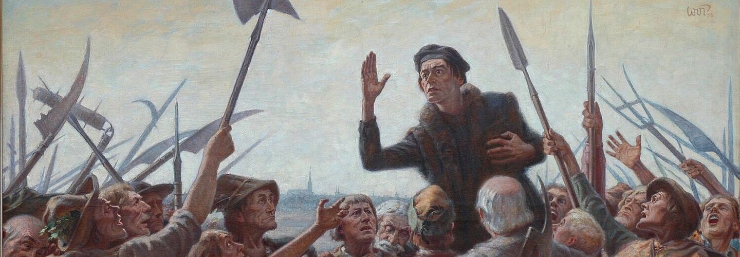 Das Bild zeigt den Reformator und Bauernführer Thomas Müntzer, der zu den aufständischen Bauern predigt. Müntzer überragt seine Zuhörer, deren teils begeisterte, teils flehenden Blicke auf ihn gerichtet sind. Die Aufständischen sind einfach gekleidet. Sie sind mit umgeschmiedeten Sensen, Spießen, Helebarden, Keulen und Beilen bewaffnet. Im Hintergrund des Bildes ist ganz schwach eine Stadt mit einer großen Kirche zu erkennen.