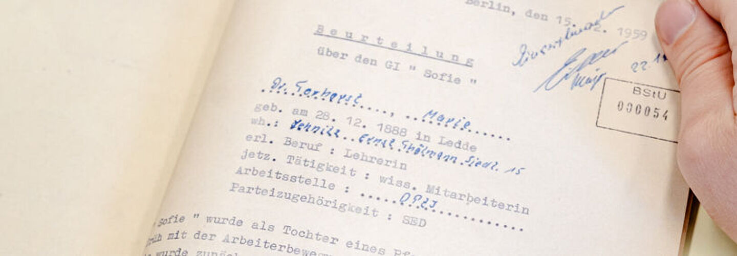 Ein Blick in die aufgeschlagene Beispielakte. Er enthält eine Beurteilung und Lebenslauf von Marie Torhorst und ihre Zusammenarbeit mit der Stasi. Am Ende wir verfügt die Akte ins Archiv zu geben.