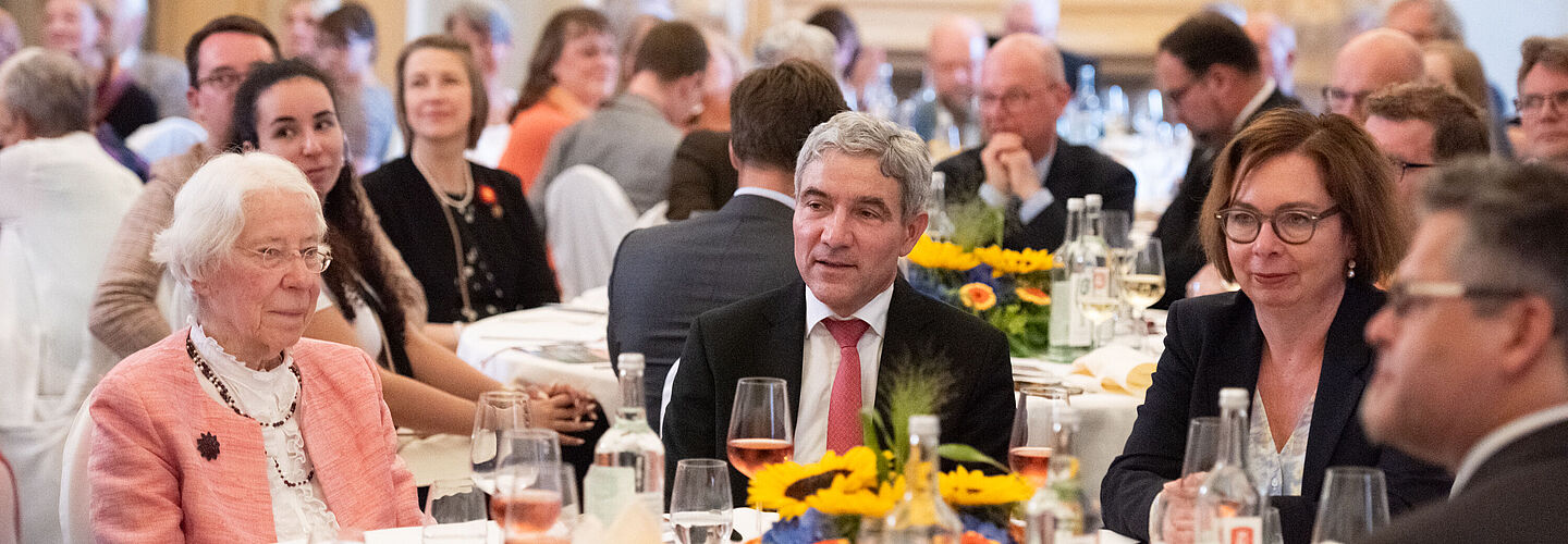 Heinemanns Tochter, Barbara Wichelhaus, sitzt am Tisch, zusammen mit Festredner Stephan Harbarth, Bundesverfassungsgerichtspräsident, und Andrea Hänger, Bundesarchivvizepräsidentin.