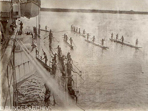 Schwarz-Weiß-Fotografie von Eingeborenen beim Tauschhandel