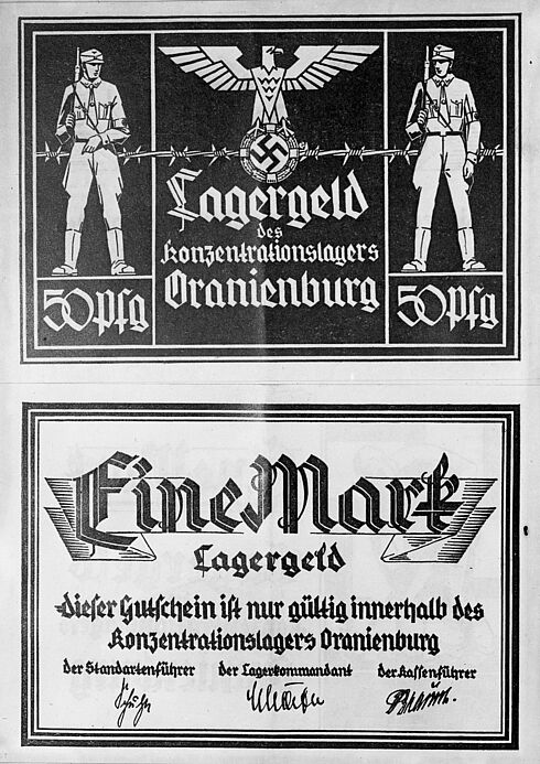 Abgebildet sind zwei Wertmarken des sogenannten "Lagergeld", welches den Inhaftierten eines Konzentrationslagers als Währung dienen sollte. Die obere Bildhälfte wird von einer 50 Pfennig-Marke eingenommen.