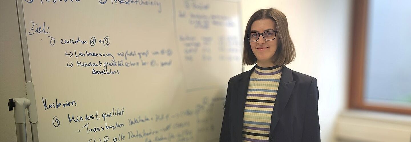 Esther-Maria Lemmerz steht vor einem beschrifteten Whiteboard.